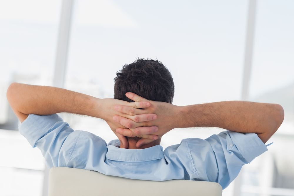 Creative business employee relaxing on his swivel chair Creative business employee relaxing on his swivel chair